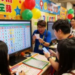 Community members excitedly checking their HK Lotto tickets at a vibrant lottery event.