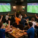 Engaging scene of fans enjoying nonton bola ive at a vibrant sports bar with live match screens.